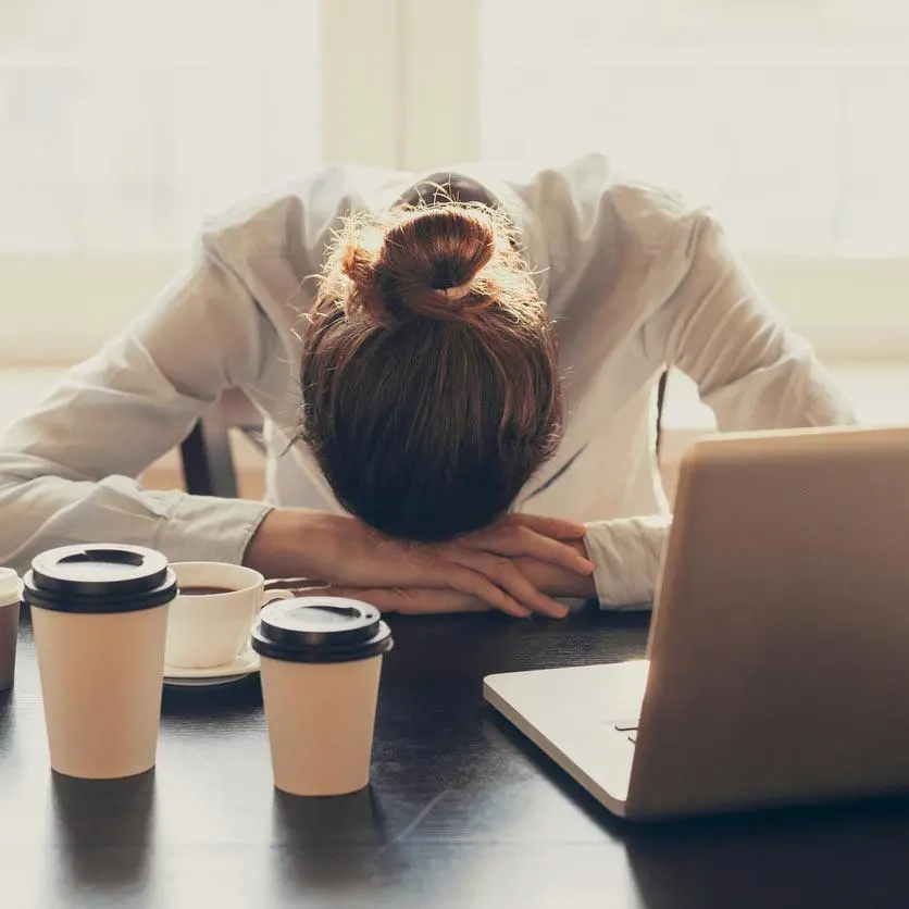 woman feeling drained and tired at work after waking up at night